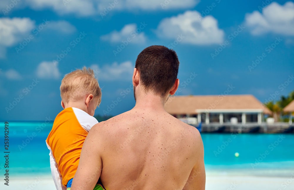 Fototapeta premium Toddler boy on beach with father