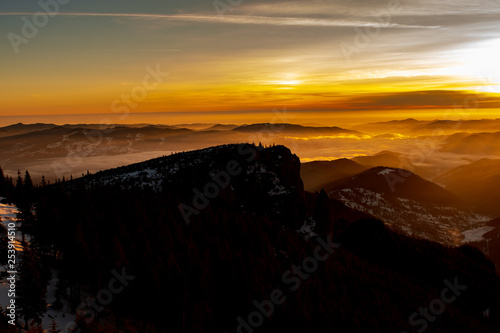 Mountain landscape with winter fog at sunse of Ceahlau  Romaniat