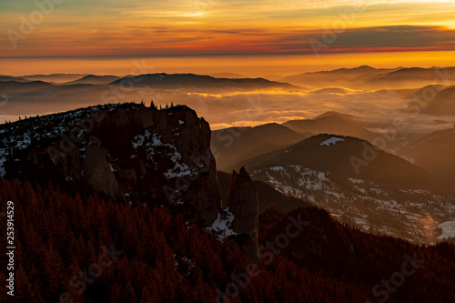 Mountain landscape with winter fog at sunse of Ceahlau, Romaniat photo