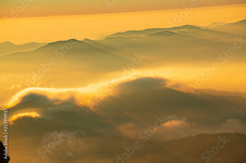Mountain landscape with winter fog at sunse of Ceahlau, Romaniat © brszattila