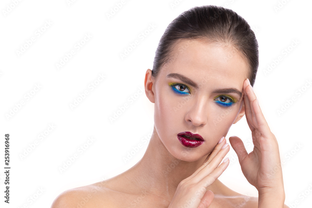 close-up portrait of a young girl with a beautiful make-up. hands near the model's face. isolated background