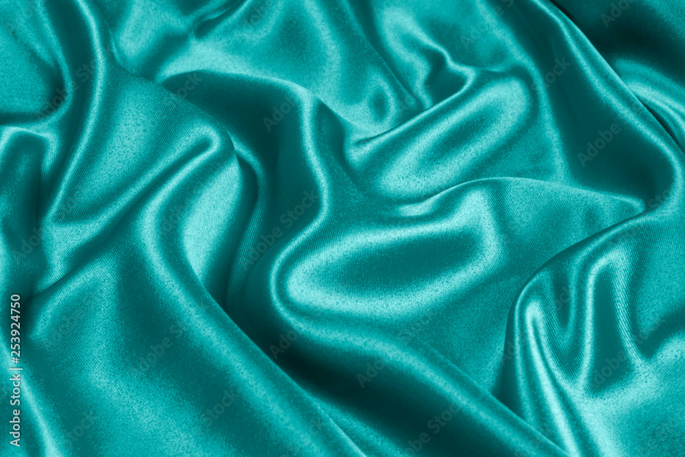 Fototapeta premium Closeup of rippled light blue satin fabric