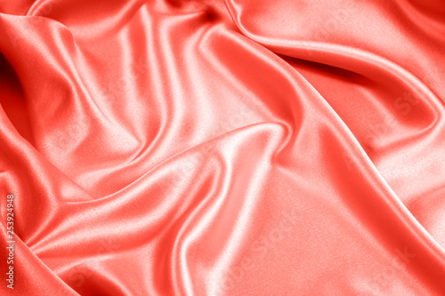 Closeup of rippled coral satin fabric