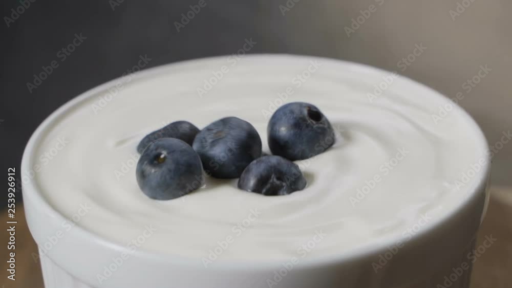 blueberry falling in to yogurt splashing in slow motion. blueberry falling in to yogurt splashing in slow motion.