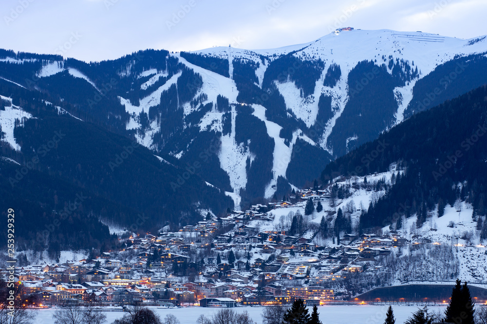 Winter panorama of Zell Am See city with ski slopes and mountains covered in snow. Famous ski resort in Austria, Europe.