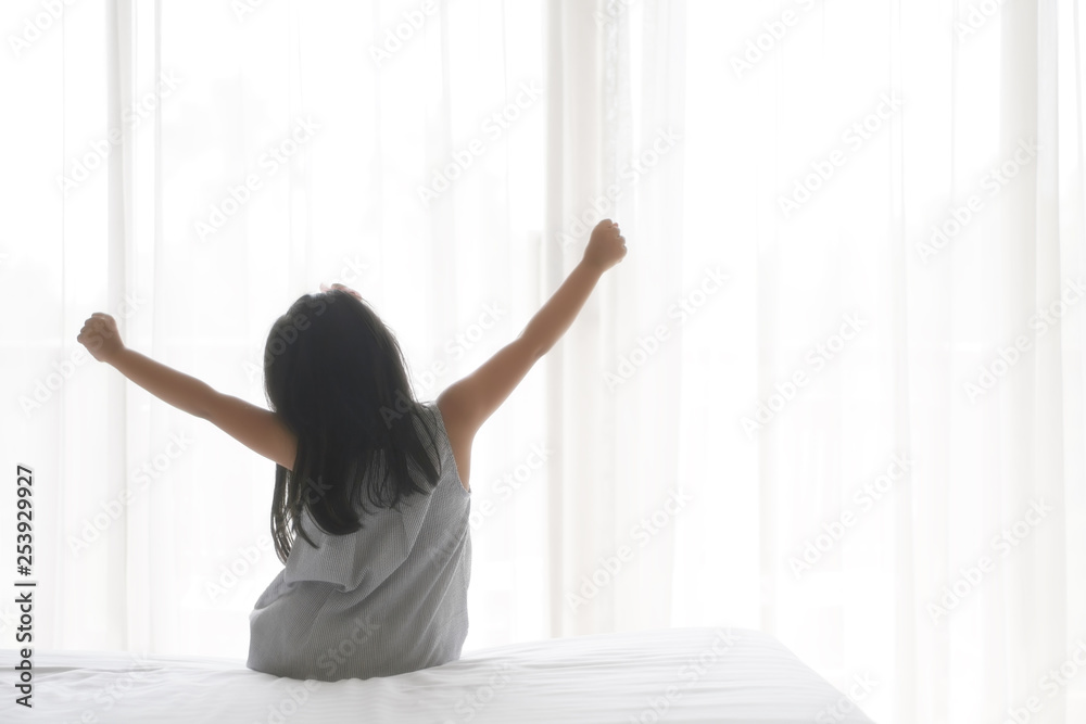 Asian child cute relax or kid girl wake up or woke up with stretch oneself after sleep for refreshing in morning on white bed and window with curtain in bedroom at home or hotel and resort on holiday Asian child cute relax or kid girl wake up or woke up with stretch oneself after sleep for refreshing in morning on white bed and window with curtain in bedroom at home or hotel and resort on holiday