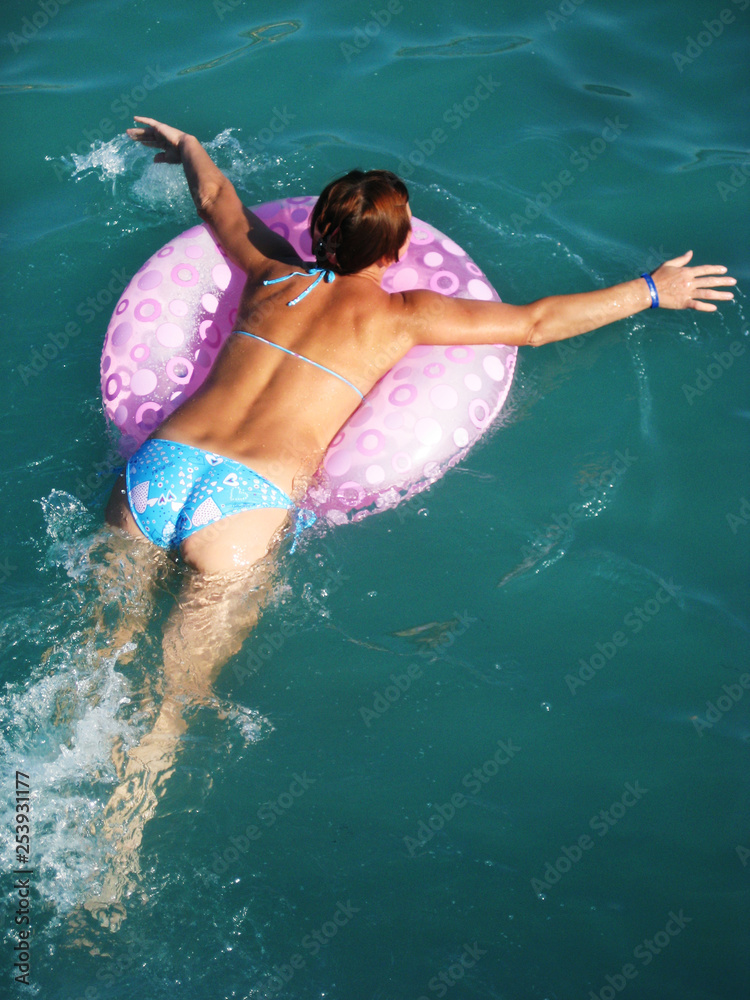 девушка радостно купается в море по кругу