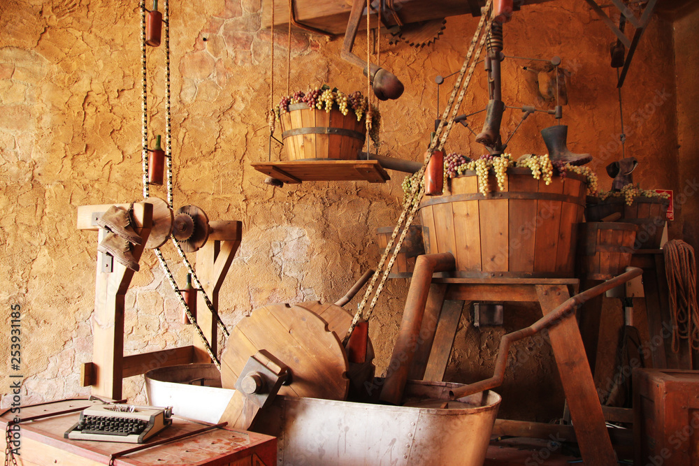 the process of making wine in an ancient semi-automatic machine for crushing grapes