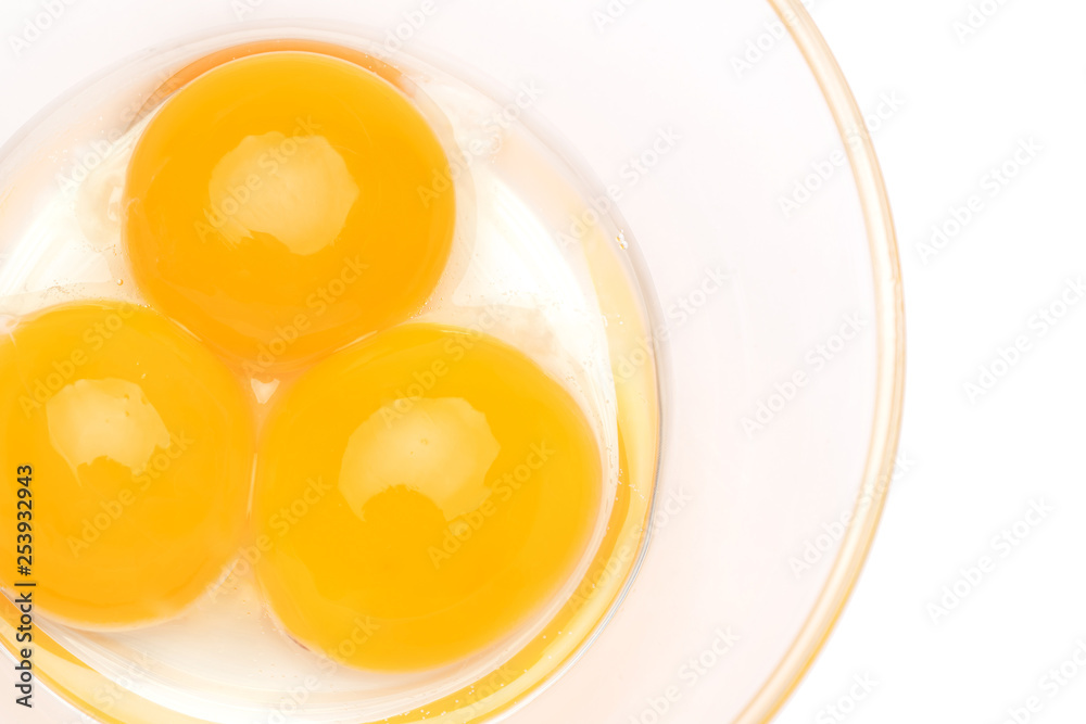 three egg yolk in a glass bowl isolated on white background three egg yolk in a glass bowl isolated on white background