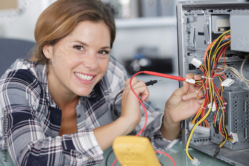 Wallpaper Mural computer repairwoman using multimeter Torontodigital.ca