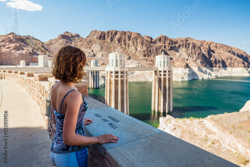 Young woman is admiring the Colorado River from the Hoover Dam in Nevada / Arizona, United States of America