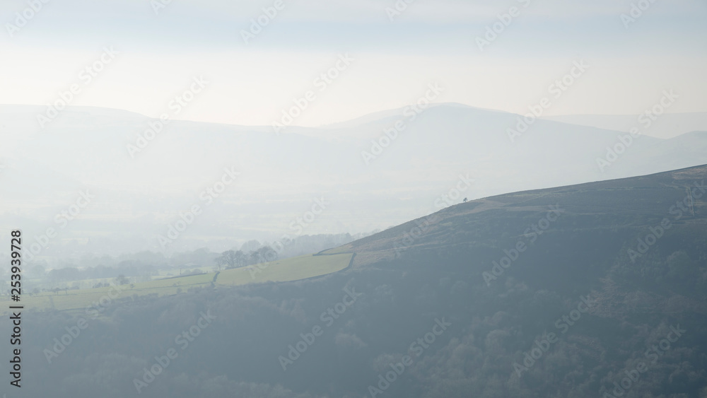 Lovely landscape image of the Peak District in England on a hazy Winter day viewed from the lower slopes of Bamford Edge