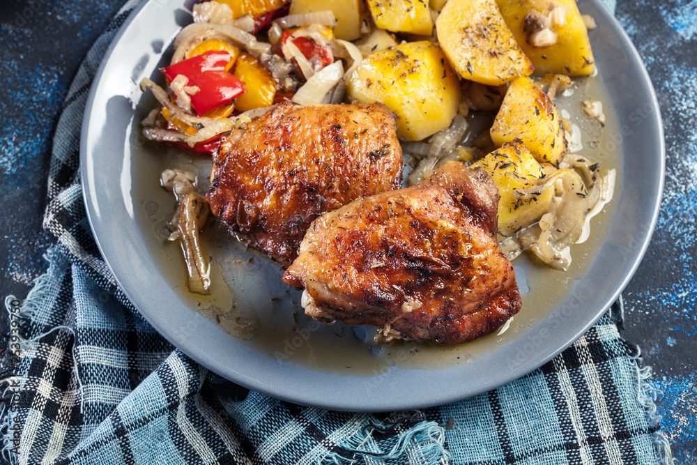 Fototapeta premium Roasted chicken thighs with potatoes