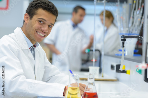 male student of chemistry working in laboratory