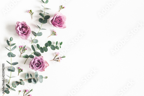 Fototapeta Naklejka Na Ścianę i Meble -  Flowers composition. Pattern made of eucalyptus branches and rose flowers on white background. Flat lay, top view, copy space