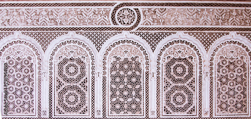 Beautiful complex exquisite carving on the plastered white walls of the Bahia Palace in the southeastern part of the medina of Marrakesh. Morocco Africa