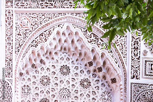 Beautiful complex exquisite carving on the plastered white walls of the Bahia Palace in the southeastern part of the medina of Marrakesh. Morocco Africa
