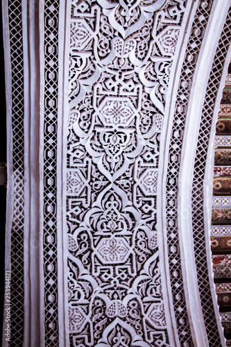 Beautiful complex exquisite carving on the plastered white walls of the Bahia Palace in the southeastern part of the medina of Marrakesh. Morocco Africa photo