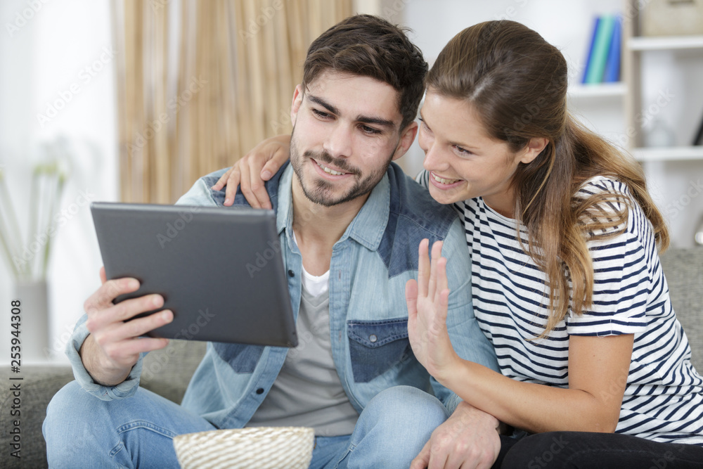 loving couple at home looking at tablet loving couple at home looking at tablet