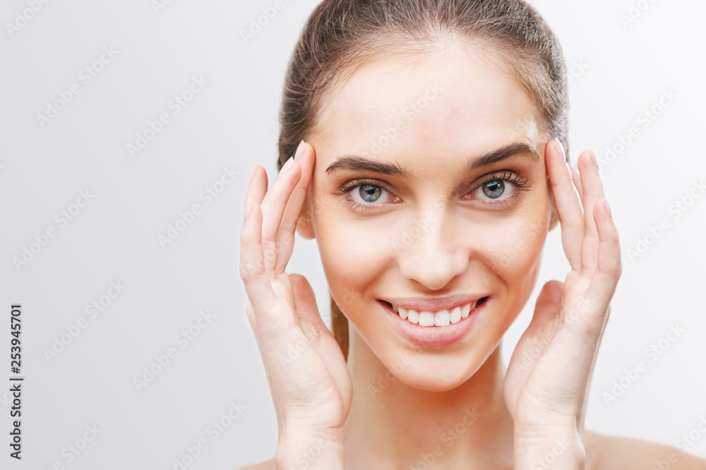 Head shot of young woman putting the cream Head shot of young woman putting the cream