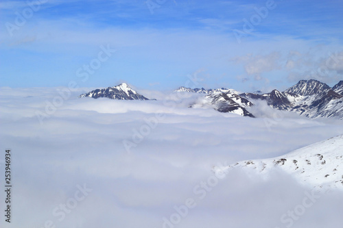 Mountain peaks over clouds. Landscape in Grandvalira ski area, Andorra.