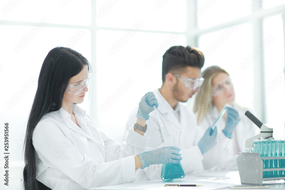 close up.modern woman sitting with colleagues at the laboratory table. close up.modern woman sitting with colleagues at the laboratory table.