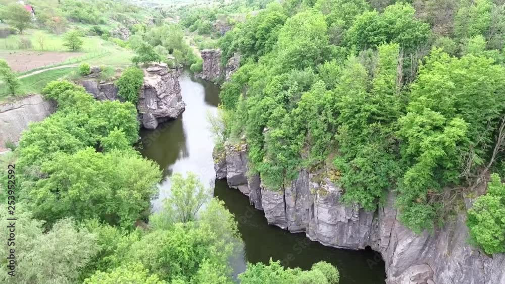 Ukrainian canyon in the village of Buki bird's-eye view. Drone removes from the height of the canyon of the Buka River, white cliffs, meadows, trees. Ukrainian canyon in the village of Buki bird's-eye view. Drone removes from the height of the canyon of the Buka River, white cliffs, meadows, trees.
