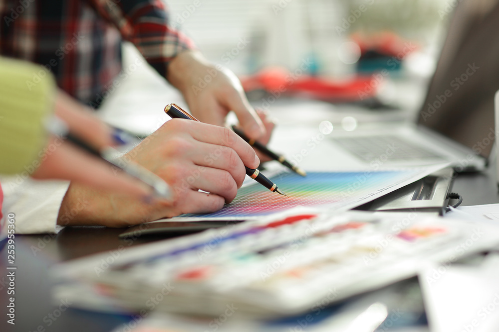 close up.a group of designers discuss the color palette close up.a group of designers discuss the color palette