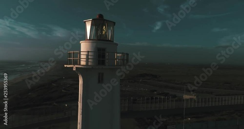 Aerial shot of a lighthouse in the beach of Tijuana with the wall of the border between Tijuana and San Diego. photo