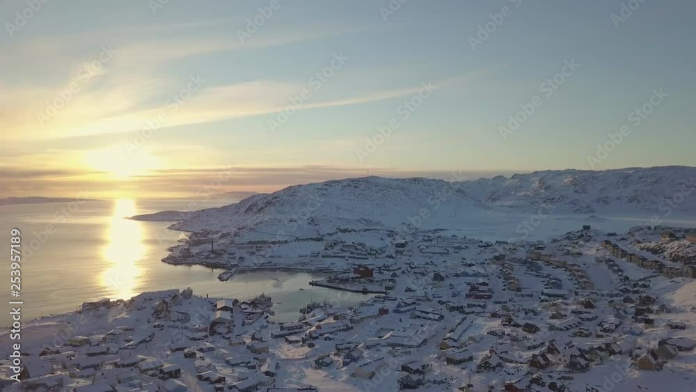 Snow town, colorful village in Covered with snow on sunset time aerial view pan left, qaqortoq south greenland europe Snow town, colorful village in Covered with snow on sunset time aerial view pan left, qaqortoq south greenland europe