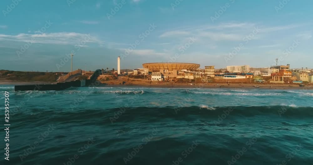 Aerial shot arriving at the beach of Tijuana from the sea. With the wall of the border with San Diego on the side and the lighthouse and the bullring at the back. Aerial shot arriving at the beach of Tijuana from the sea. With the wall of the border with San Diego on the side and the lighthouse and the bullring at the back.