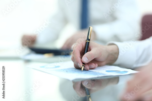 Close up. the businessman checks the financial schedule