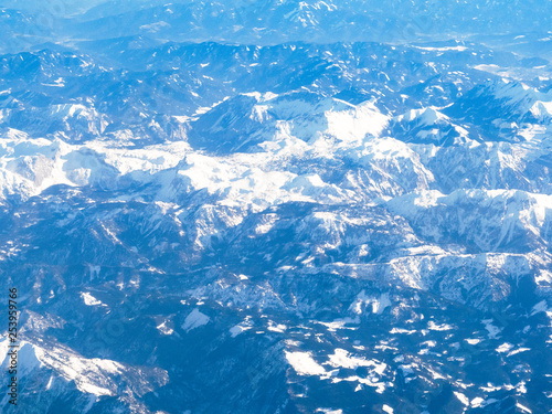 above view of tops of Alps mountain from airplane