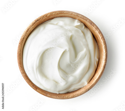 sour cream or yogurt in wooden bowl photo