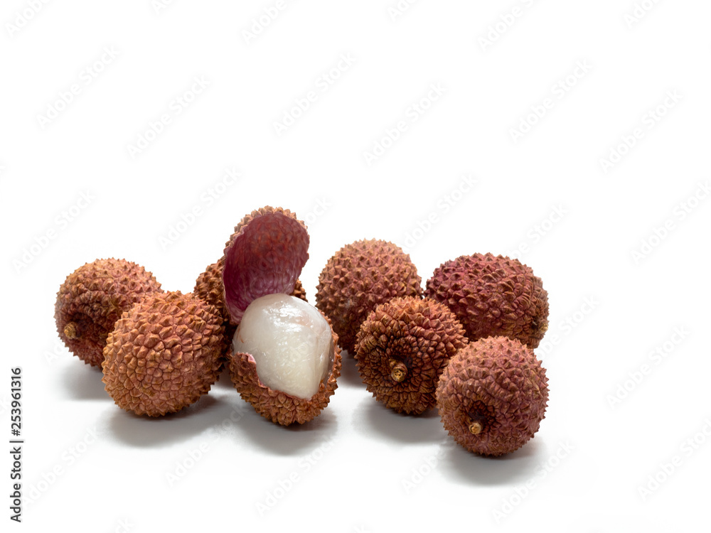 Several lychee fruits, one with open peel Several lychee fruits, one with open peel