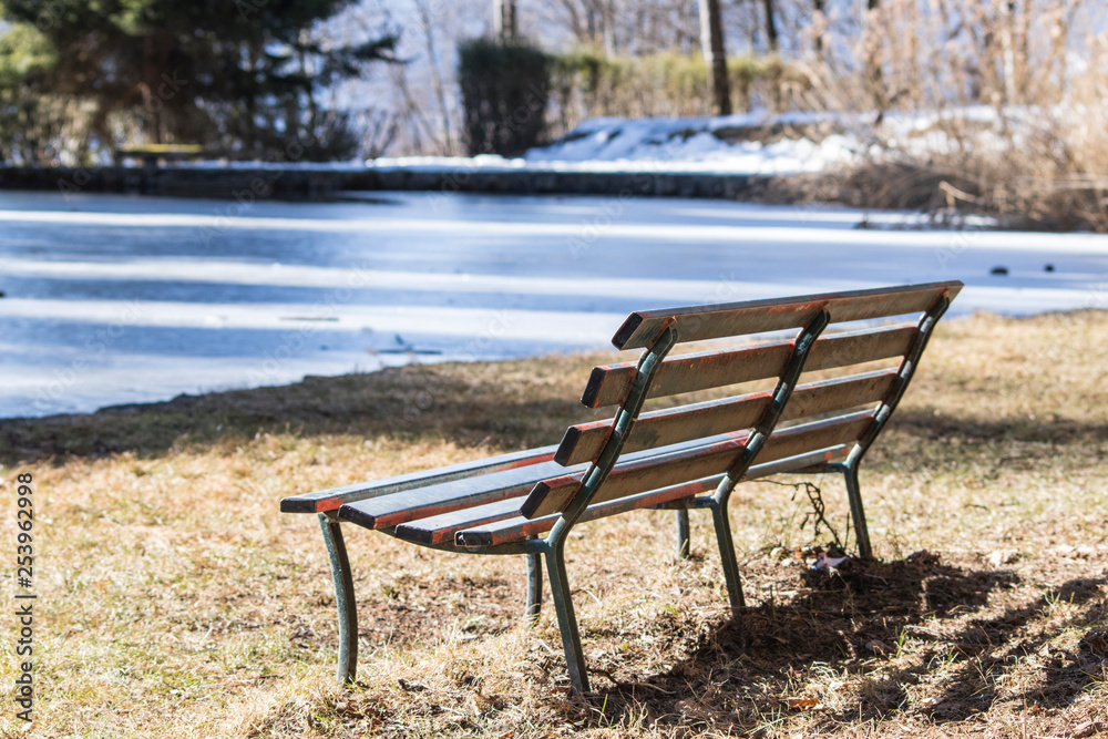 Relaxing place, bench near a lake during winter Relaxing place, bench near a lake during winter