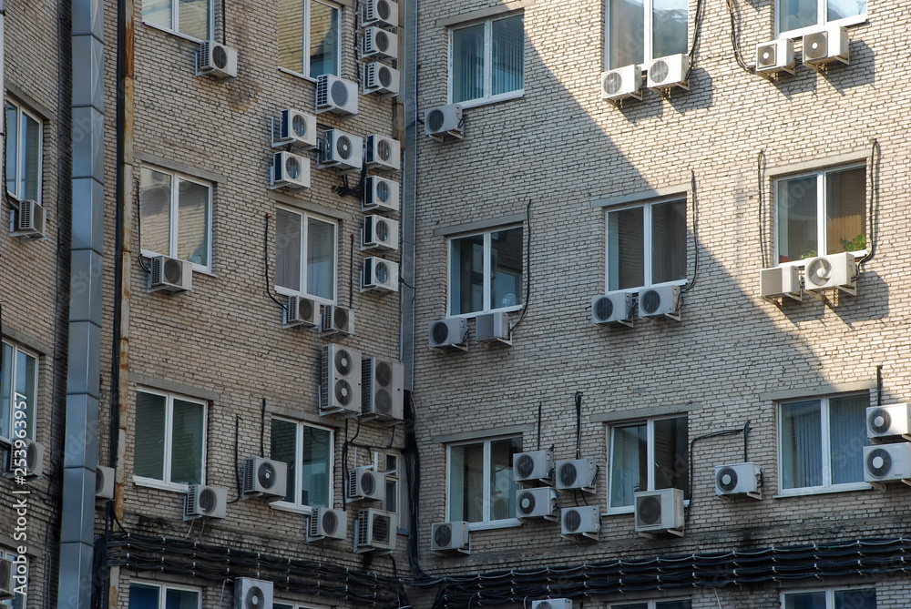 aapartment building with a lot of windows and air conditioner outside