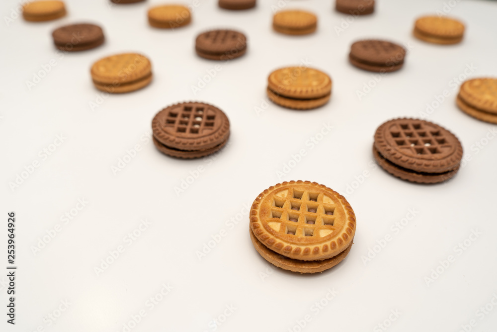 Delicious cookies with cream for breakfast on a white background. Perspective Delicious cookies with cream for breakfast on a white background. Perspective