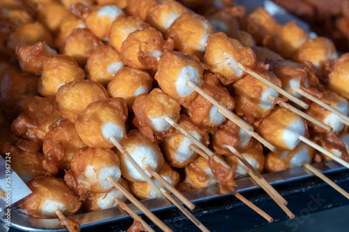 Fried balls in deep fat with sticks, Thai style food. Street fast food in Thailand, closeup