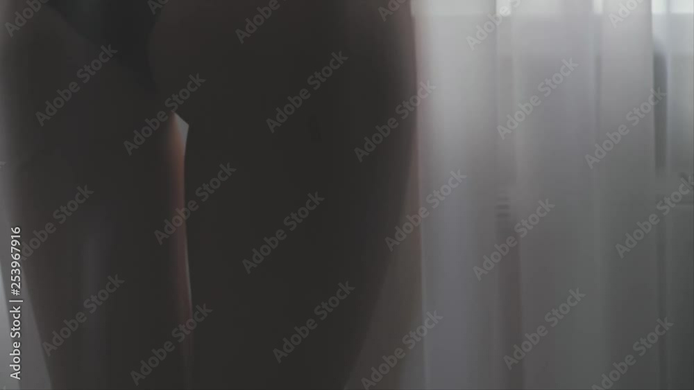 Woman near window in underwear with glass of wine, shallow depth of field Woman near window in underwear with glass of wine, shallow depth of field