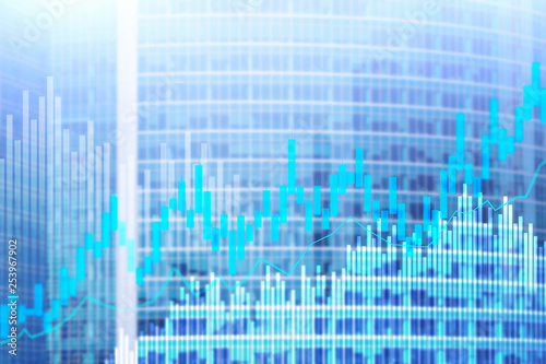 Stock trading candlestick chart and diagrams on blurred office center background.