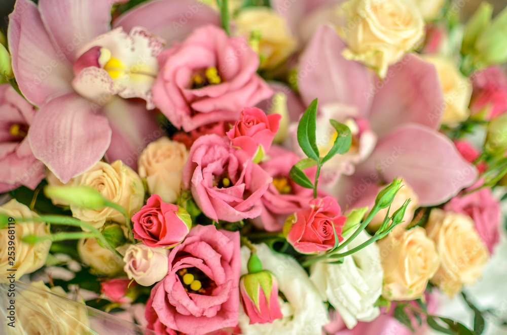 Bouquet with orchids and roses on a beautiful background