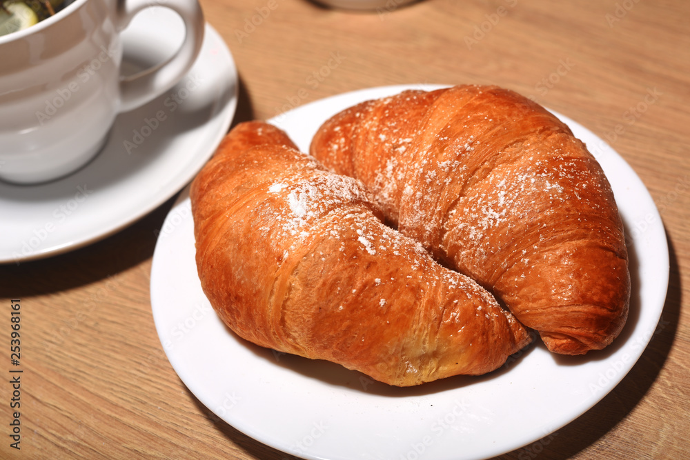 Croissants on a plate on a wooden table. Homemade croissants