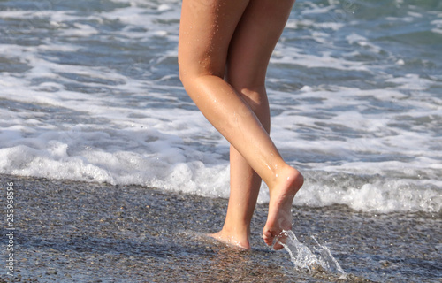 Girl's legs in the water of the sea © schankz