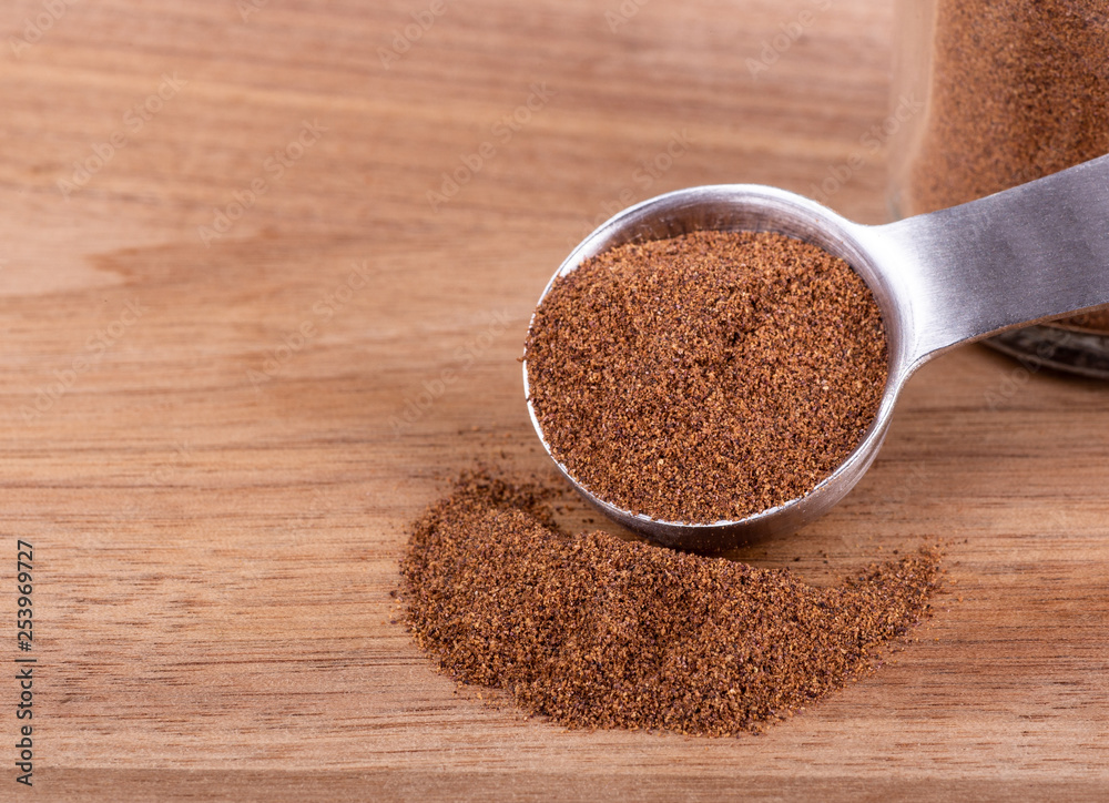 Ground Allspice on a Wooden Table Ground Allspice on a Wooden Table