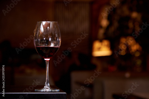 A glass of red wine on a dark background. Copy space.
