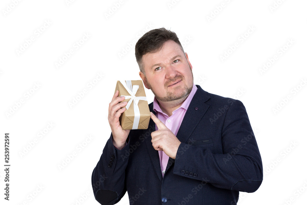 Large adult man with a small gift in his hands. Isolate A fat man with a beard holding a gift box on a white background. Large adult man with a small gift in his hands. Isolate A fat man with a beard holding a gift box on a white background.