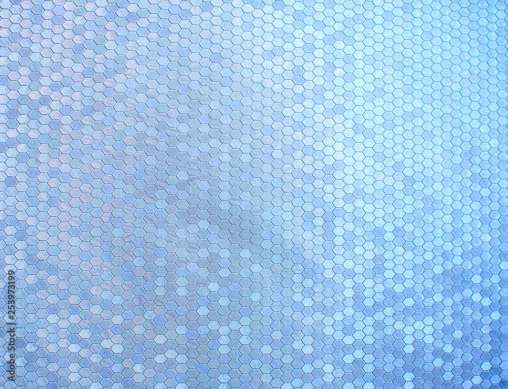 Texture of artificial radiant skin with honeycomb perforation. Abstract background, defocus.