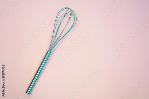  whisk on  pink pastel background. Top view  minimalism