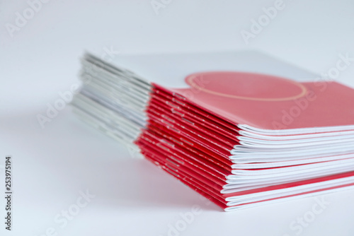 Pile of advertising magazines on a white background.